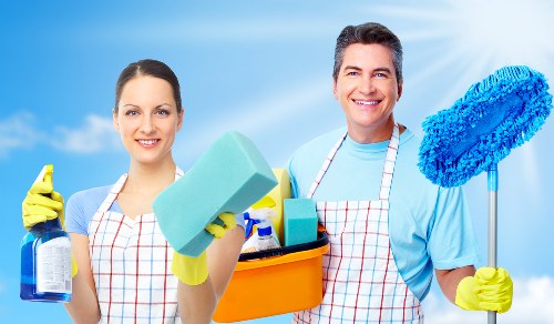 Operator using carpet cleaning equipment with safe handling procedures